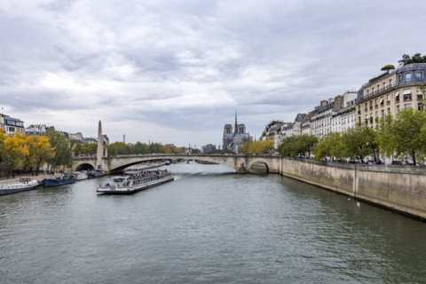 Sightseeing boat on Seine River at Ile Saint-Louis. Paris, Ile de France, France.