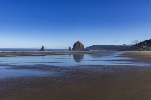 Cannon Beach at low tide with Haystack Rock in background. , Oregon, USA.