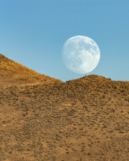 Moon rising over rocky hillside. Bellevue, Idaho, USA.