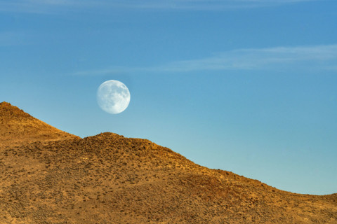 Moon rising over rocky hillside. Bellevue, Idaho, USA.