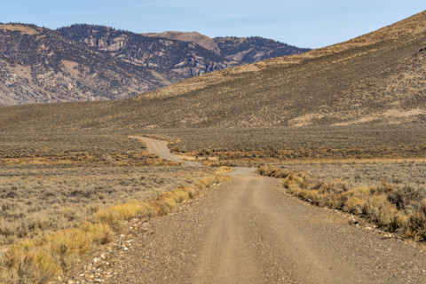 Empty rural dirt road over Trail Creek Pass. Mackay, Idaho, USA.