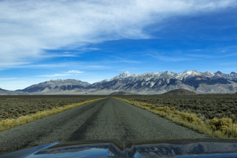 Empty rural road over Trail Creek Pass seen from vehicle. Mackay, Idaho, USA.