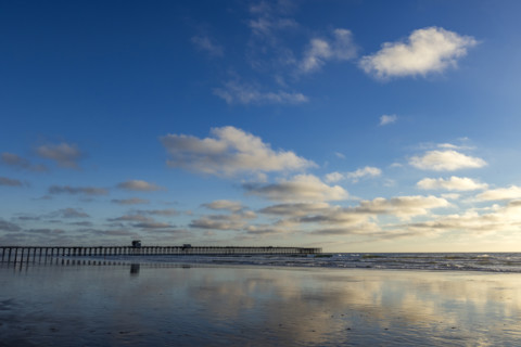 Oceanside Pier and calm ocean in late afternoon. Oceanside, California, USA.