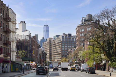 Traffic on street with One World Trade Center in background. New York City, New York State, USA.