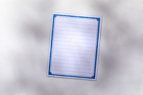 Blank lined notepad on white background. New York City, New York State, USA.