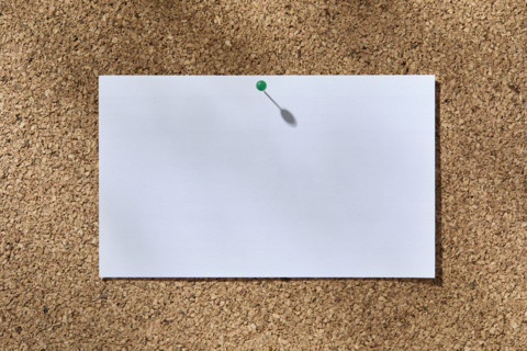 Blank white notecard on corkboard. New York City, New York State, USA.