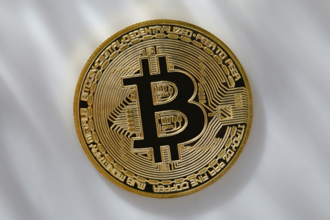 Bitcoin on dappled light background. New York City, New York State, USA.