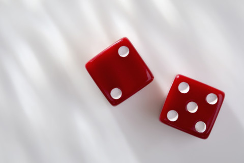 Two red dice on white background. New York City, New York State, USA.