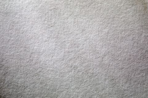 Dappled light on textured white paper. New York City, New York State, USA.