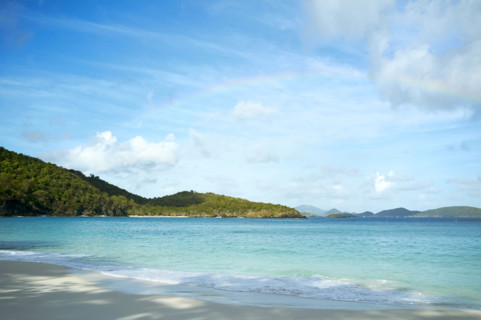 Rainbow over turquoise water of Trunk Bay. New York City, New York State, USA.