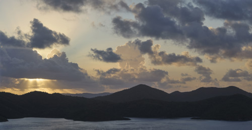 Clouds over mountains and ocean at sunrise. New York City, New York State, USA.