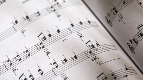 Closeup-of sheet music in dappled light. New York City, New York State, USA.