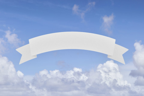 Blank banner in front of blue sky and white clouds. New York City, New York State, USA.