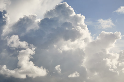 White puffy cumulous clouds and blue sky. New York City, New York State, USA.