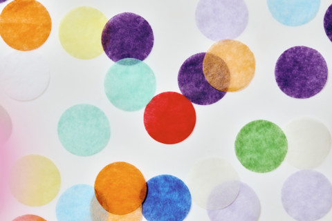 Close-up of colorful confetti on white background. New York City, New York State, USA.