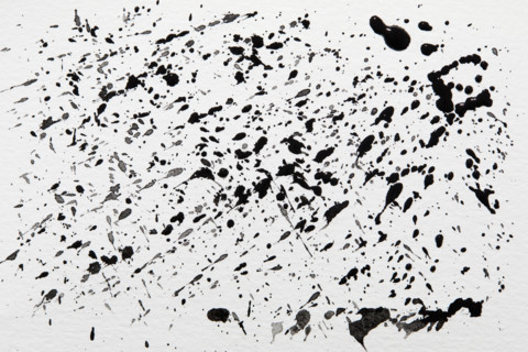 Black paint spatter on white background. New York City, New York State, USA.