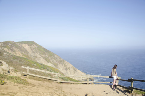 Woman looking at view at Point Reyes National Seashore, Inverness, California, USA.