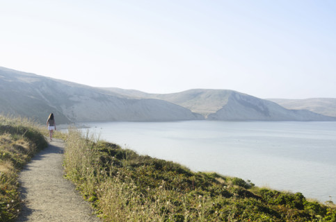 Rear view of woman on path at Drakes Bay, Inverness, California, USA.