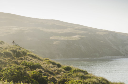 Rear view of woman on path at Drakes Bay, Inverness, California, USA.