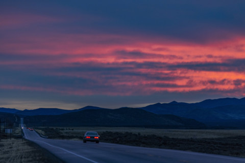 Car on highway 20 at sunrise, Belleuve, Idaho, USA.