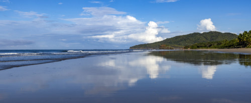 Sky and clouds reflecting in calm sea surface at dawn, Playa Grande, Guanacaste, Costa Rica.