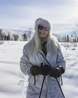 Portrait of smiling senior woman in snowy landscape, Sun Valley, Idaho, USA.