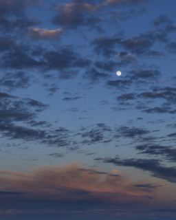 Moon rising on cloudy sky, Kettleman City, California, USA.