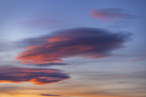 Pink lenticular clouds on sky at sunset, Gordes, Vaucluse, France.