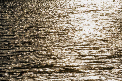 Sunlight reflected in rippled water surface, Bellevue, Idaho, USA.