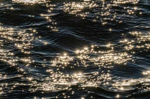 Sunlight reflected in rippled water surface, Bellevue, Idaho, USA.