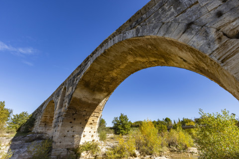 Low angle view of 3rd century Roman bridge, Pont Julien, on sunny day, Bonnieux, Vaucluse, France.