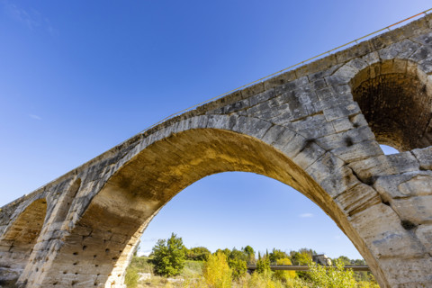 Low angle view of 3rd century Roman bridge, Pont Julien, on sunny day, Bonnieux, Vaucluse, France.