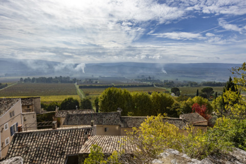 Luberon valley with agricultural burning, Gordes, Vaucluse, France.