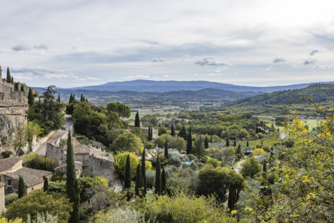 Old houses and trees in Luberon Valley, Gordes, Vaucluse, France.