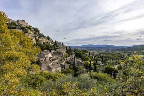 Old houses and trees in Luberon Valley, Gordes, Vaucluse, France.