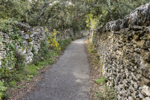 Empty path between old stone walls, Gordes, Vaucluse, France.