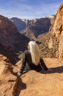 Rear view of senior blonde woman at Zion Overlook, Zion National Park, Utah, USA.
