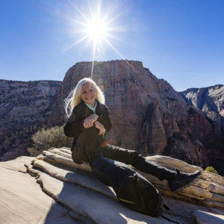 Portrait of smiling senior woman atop Angels Landing, Zion National Park, Utah, USA.