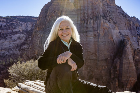 Portrait of smiling senior woman atop Angels Landing, Zion National Park, Utah, USA.