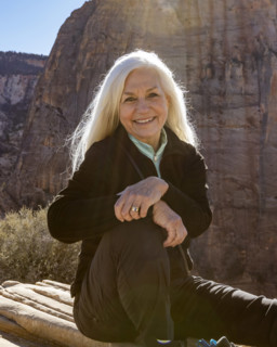 Portrait of smiling senior woman atop Angels Landing, Zion National Park, Utah, USA.