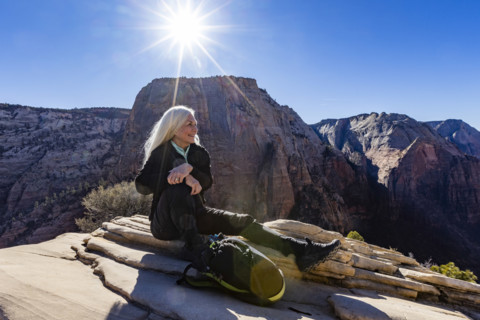 Smiling senior woman atop Angels Landing, Zion National Park, Utah, USA.