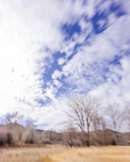 Clouds above fields and trees, blurred motion, Bellevue, Idaho, USA.