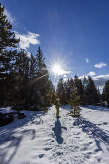 Senior woman snowshoeing in Sun Valley, Sun Valley, Idaho, USA.