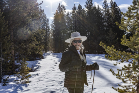 Portrait of smiling senior woman snowshoeing in Sun Valley, Sun Valley, Idaho, USA.