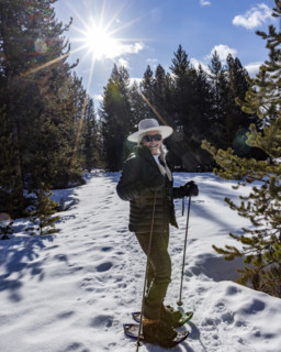 Portrait of smiling senior woman snowshoeing in Sun Valley, Sun Valley, Idaho, USA.
