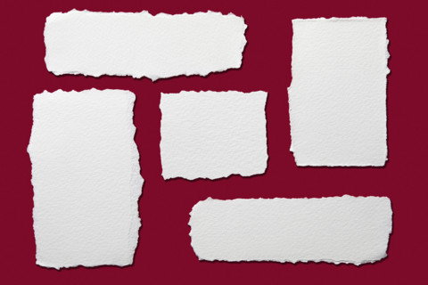 Torn paper on red background, New York City, New York, USA.