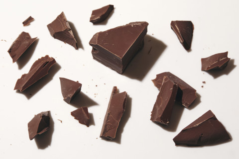 Broken block of chocolate on white background, New York City, New York, USA.