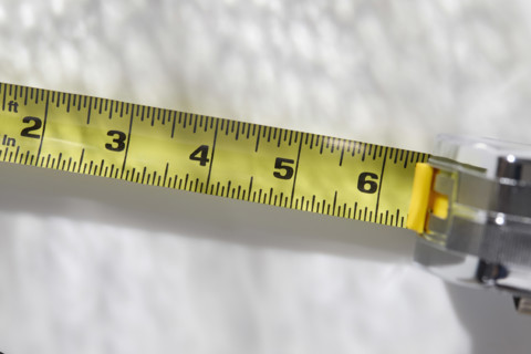 Close-up of tape measure on white background, New York City, New York, USA.