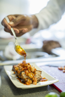 Close-up of chef making pork belly and kimchee in restaurant, Los Angeles, California, USA.