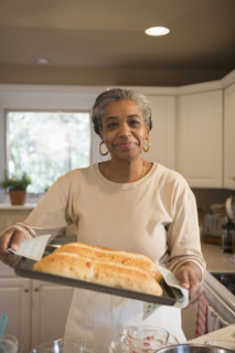 Portrait of smiling woman baking in kitchen, Richmond, Virginia, USA.